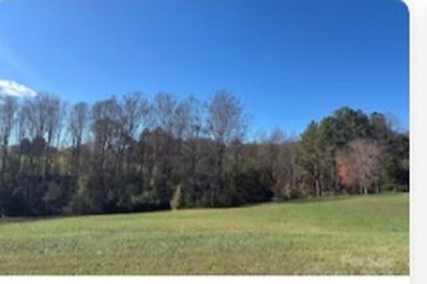 Sold open pasture lot bordered by treeline on Fairway Drive in Forest City, North Carolina